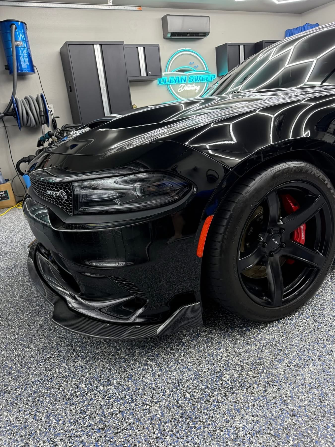 Black Dodge Charger SRT with reflections across its hood and front fender from the Clean Sweep Detailing portfolio