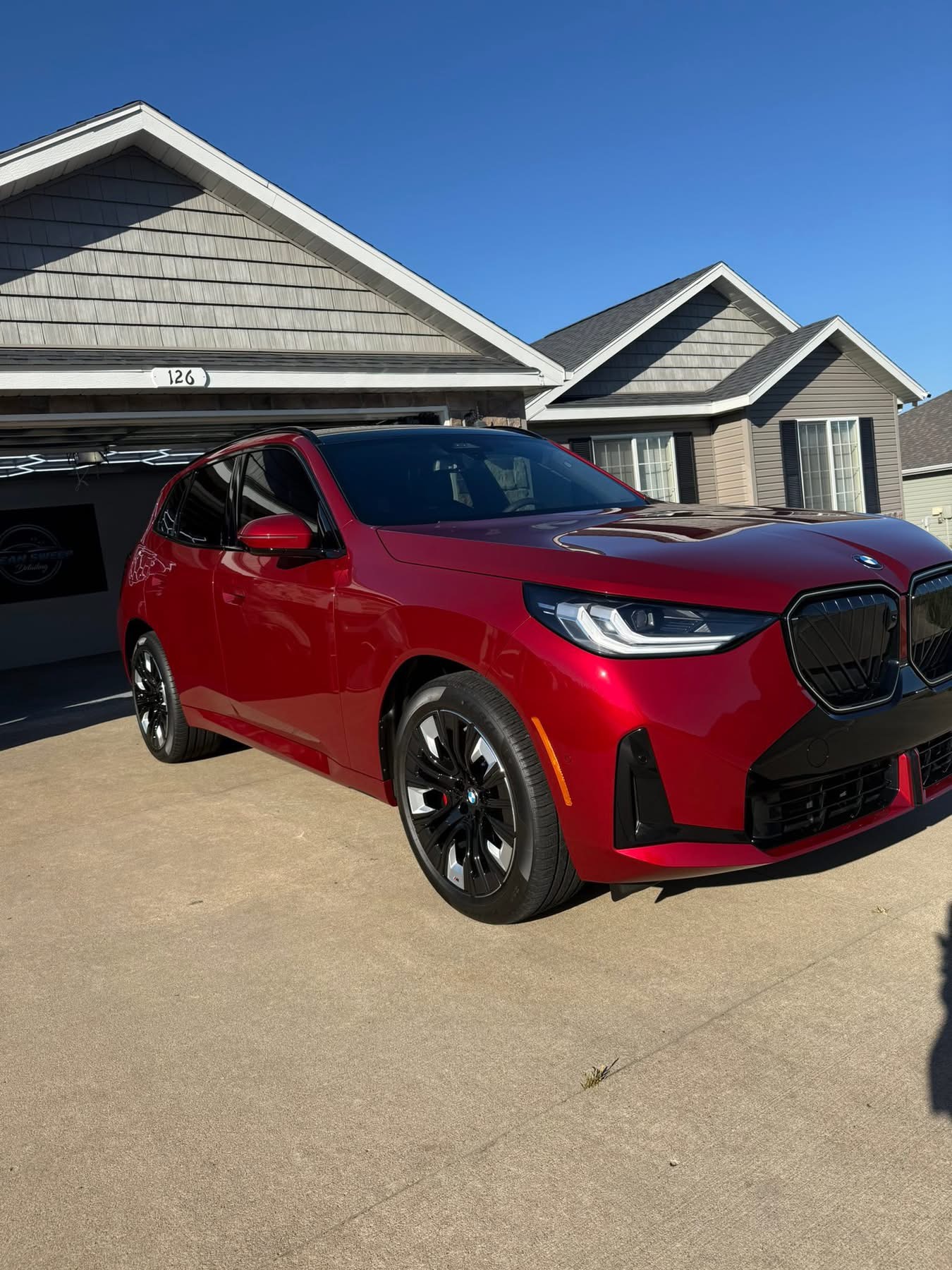 Red BMW SUV photographed outdoors from the Clean Sweep Detailing portfolio